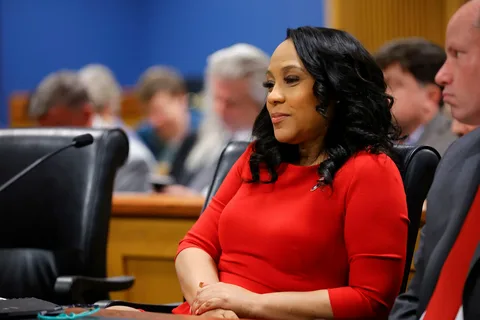 Fani Willis sitting with her legal team in court