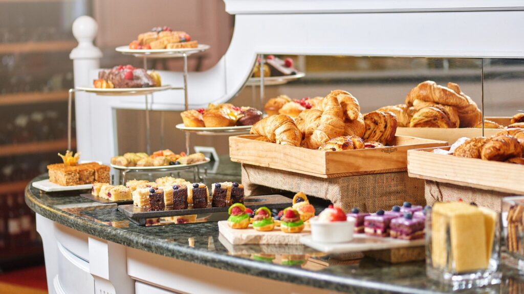 A delicious breakfast spread arranged for a morning office meeting in London, featuring pastries, fruit cups, and fresh coffee.