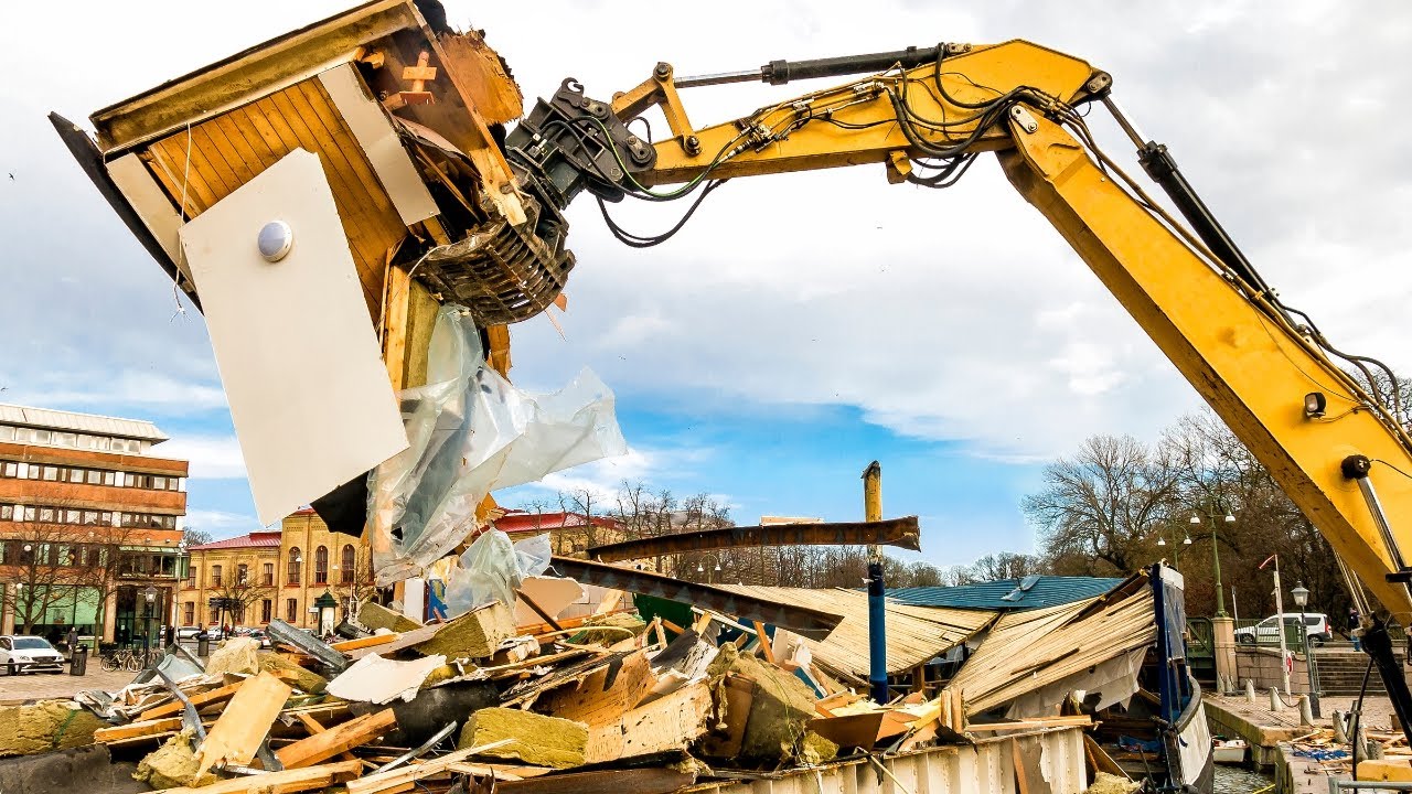 Worker removing drywall during light demolition.